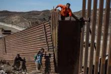 Un migrante centroamericano se cruza el muro con Estados Unidos el 25 de noviembre. Unos 200  migrantes intentaron cruzar la frontera ese mismo día, decenas de ellos fueron capturados por la Patrulla Fronteriza de Estados Unidos.  